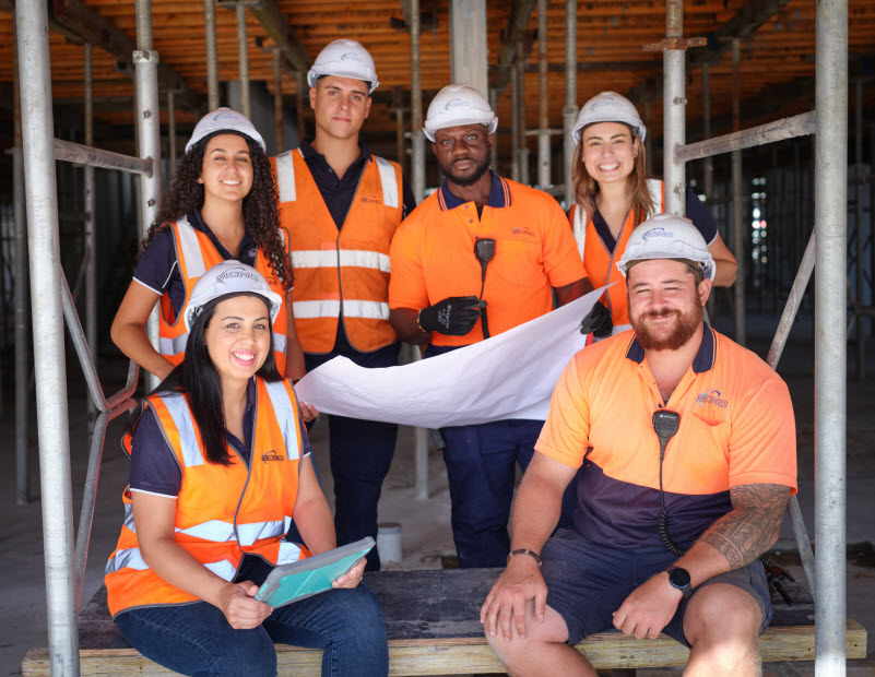 Workers wearing uniform and vests in a construction site