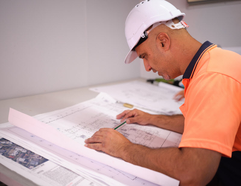 Architect using a ruler checking the design of the floor plan